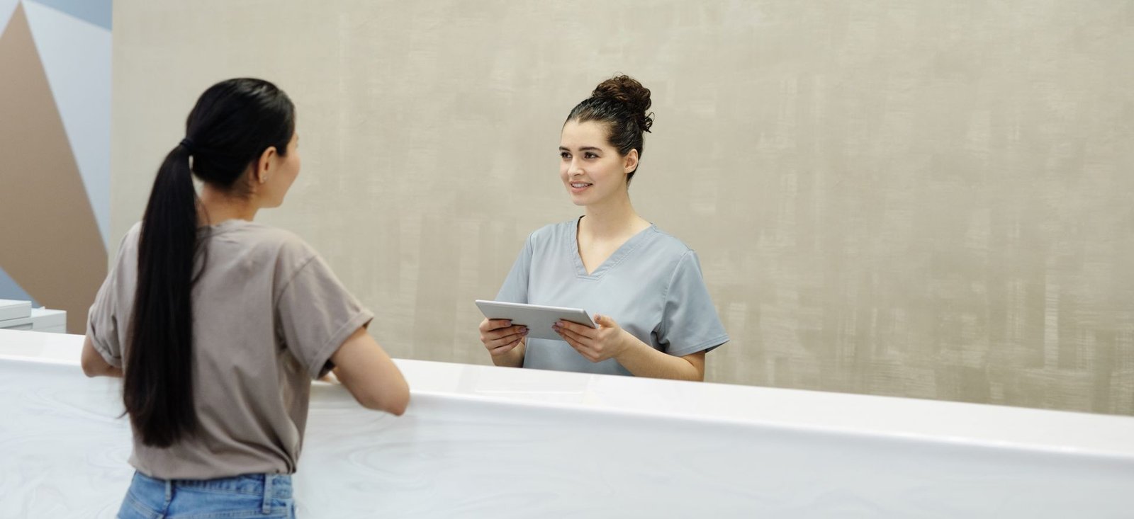 Reception team member assisting a patient at Cringila General Medical Practice