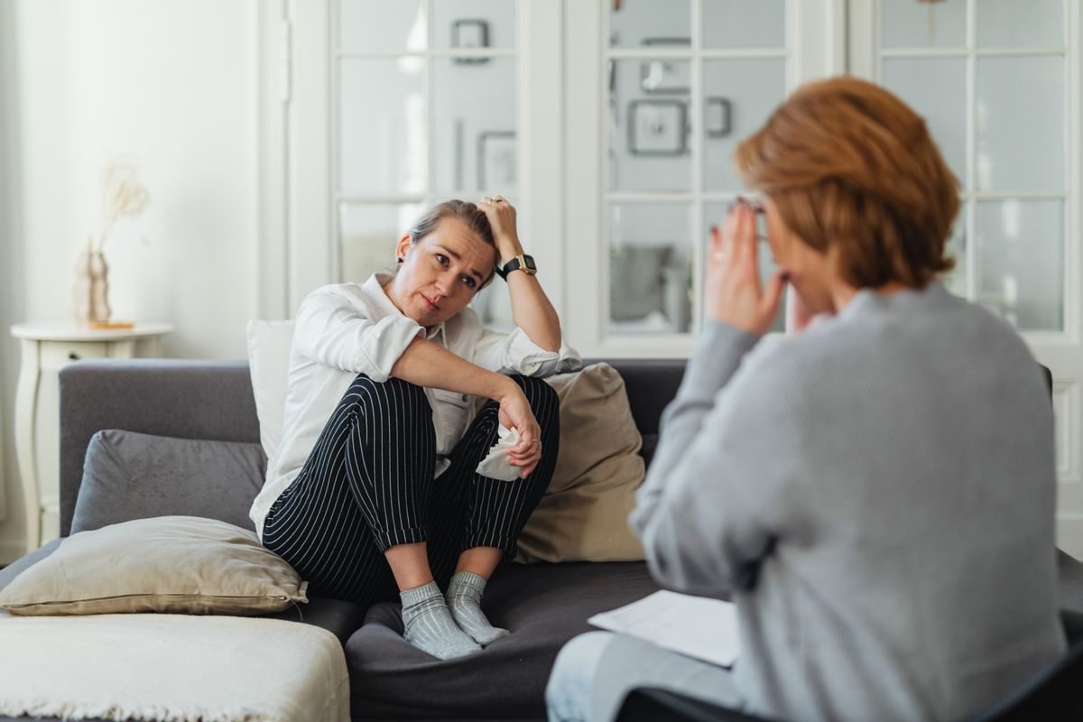 A counsellor listening supportively during a mental health consultation