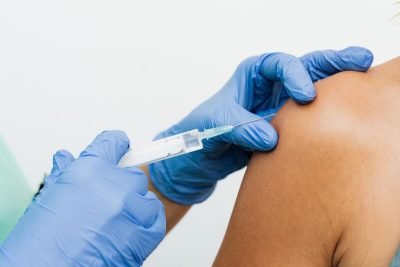 A nurse administering a flu vaccination injection